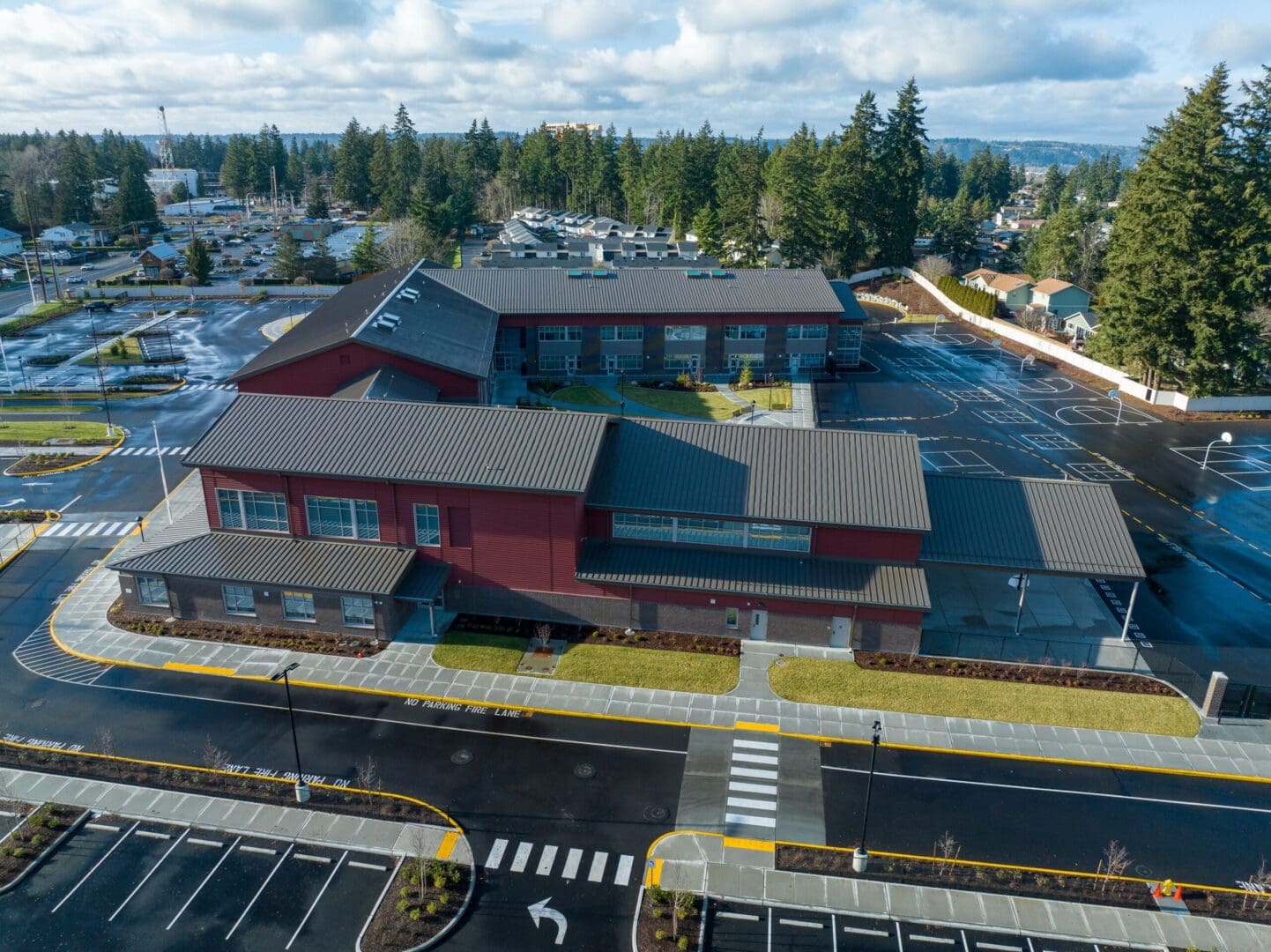 An aerial view of a school building in a parking lot.