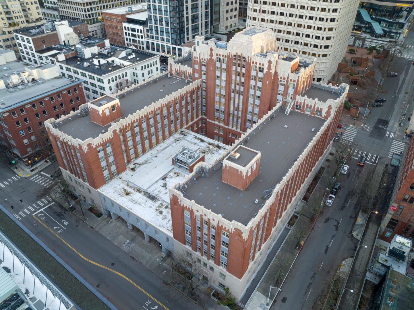 An aerial view of a brick building in a city.