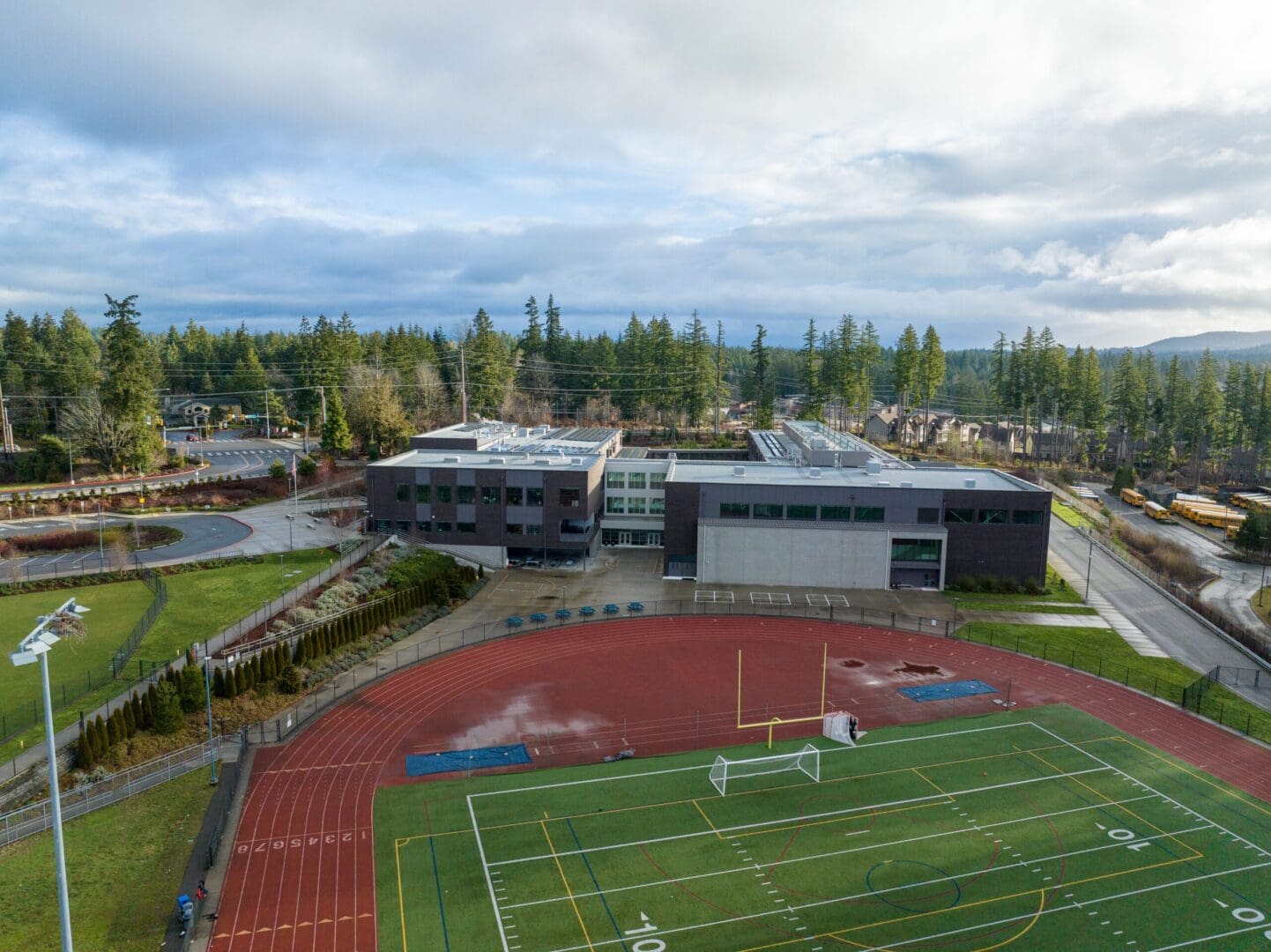 An aerial view of a school with a soccer field.